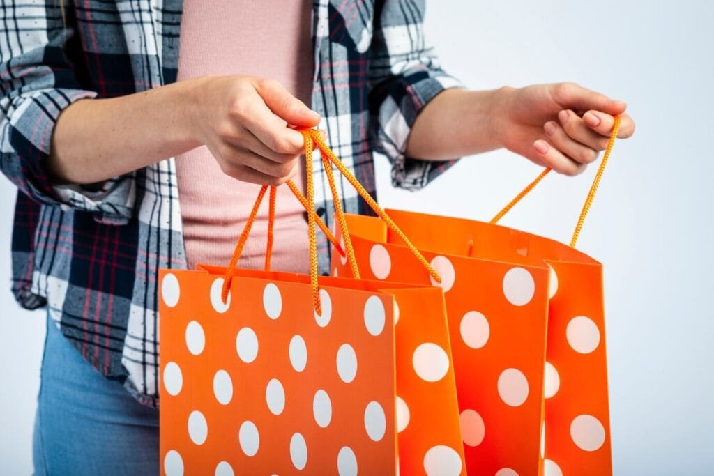 Bags hands opening polka dot shopping bags 23 2148316658